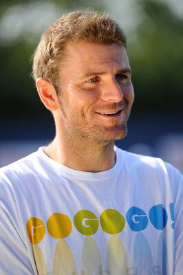 NEW YORK, NY - AUGUST 26:  Mardy Fish of the United States looks on prior to taking part in a Guinness World Record attempt for the most people to bounce a tennis ball on their racquet in one location prior to the start of the 2011 U.S. Open at the USTA B