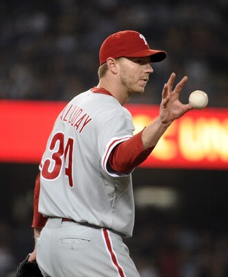 LOS ANGELES, CA - AUGUST 08:  Roy Halladay #34 of the Philadelphia Phillies catches a ball after a play to first base against the Los Angeles Dodgers during the fifth inning at Dodger Stadium on August 8, 2011 in Los Angeles, California.  (Photo by Harry