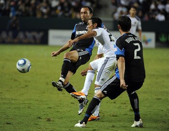 CARSON, CA - AUGUST 20:  Miguel Lopez #25 of the Los Angeles Galaxy passes the ball away from Ramiro Corrales #12 and Bobby Burling #2 of the San Jose Earthquakes during the second half at The Home Depot Center on August 20, 2011 in Carson, California.  (