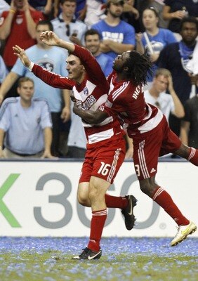 KANSAS CITY, KS - AUGUST 27:   Bobby Warshaw #16 of the FC Dallas celebrates his second half goal with Ugo Ihemelu #3 as Kei Kamara #23 of the Sporting KC looks on during their MLS match at Livestrong Sporting Park during an MLS match on August 27, 2011 i