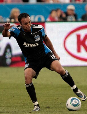 TORONTO, CANADA - AUGUST 27: Julian de Guzman #6 of Toronto FC slides into Ramiro Corrales #12 of San Jose Eathquakes during MLS action at BMO Field August 27, 2011 in Toronto, Ontario, Canada. (Photo by Abelimages/Getty Images)