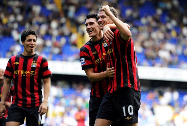 LONDON, ENGLAND - AUGUST 28:  Edin Dzeko (R) of Manchester City celebrates scoring his fourth goal with teammates Gareth Barry and Sami Nasri (L) during the Barclays Premier League match between Tottenham Hotspur and Manchester City at White Hart Lane on