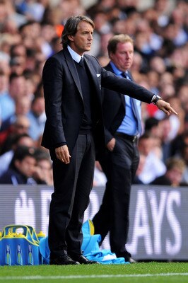 LONDON, ENGLAND - AUGUST 28:  Roberto Mancini manager of Manchester City (R) issues instructions to his players as Harry Redknapp manager of Tottenham looks on during the Barclays Premier League match between Tottenham Hotspur and Manchester City at White