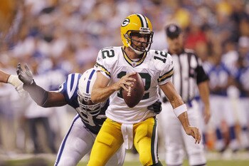 INDIANAPOLIS, IN - AUGUST 26: Aaron Rodgers #12 of the Green Bay Packers gets sacked by Dwight Freeney #93 of the Indianapolis Colts during the first half of an NFL preseason game at Lucas Oil Stadium on August 26, 2011 in Indianapolis, Indiana. (Photo by