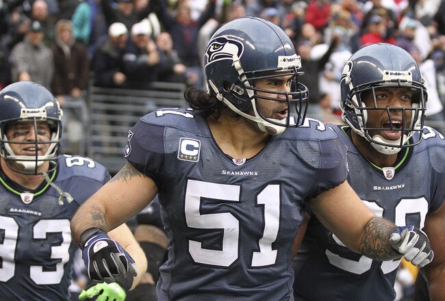 SEATTLE, WA - DECEMBER 05:  Linebacker Lofa Tatupu #51 of the Seattle Seahawks celebrates with Jay Richardson #99 and Craig Terrill #93 after returning an interception for a touchdown against the Carolina Panthers at Qwest Field on December 5, 2010 in Sea