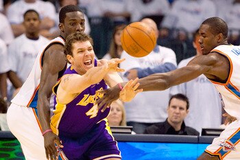 OKLAHOMA CITY - APRIL 24: Luke Walton #4 of the Los Angeles Lakers passes the ball against Jeff Green #22 and Serge Ibaka #9 both of the Oklahoma City Thunder during Game Four of the Western Conference Quarterfinals of the 2010 NBA Playoffs on April 24, 2