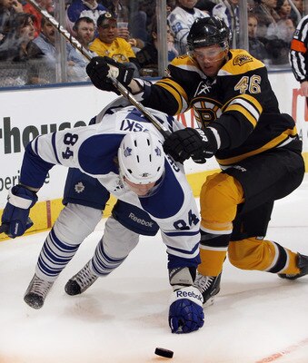 TORONTO, CANADA - DECEMBER 4: Mikhail Grabovski #84 of the Toronto Maple Leafs battles for the puck with David Krejci #46of the Boston Bruins during game action at the Air Canada Centre December 4, 2010 in Toronto, Ontario, Canada. (Photo by Abelimages /