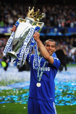 LONDON, ENGLAND - MAY 09:  Ashley Cole of Chelsea celebrates with the trophy as they win the title after the Barclays Premier League match between Chelsea and Wigan Athletic at Stamford Bridge on May 9, 2010 in London, England. Chelsea won 8-0 to win the