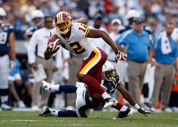 SAN DIEGO - JANUARY 03:  Malcolm Kelly #12 of the Washington Redskins breaks a tackle from Dante Hughes #24 of the San Diego Chargers in the second half at Qualcomm Stadium on January 3, 2010 in San Diego, California. The Chargers defeated the Redskins 23