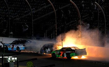 DAYTONA BEACH, FL - JULY 01:  Aric Almirola, driver of the #88 Suave Men Chevrolet, Elliott Sadler, driver of the #2 OneMain Financial Chevrolet and Danica Patrick, driver of the #7 GoDaddy.com Chevrolet, collide during the NASCAR Nationwide Series Subway