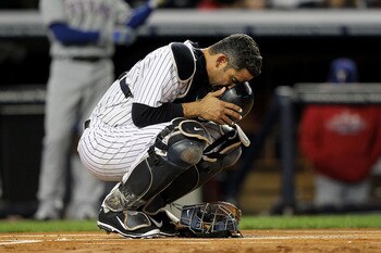 NEW YORK - OCTOBER 18:  Catcher Jorge Posada #20 of the New York Yankees draws in the dirt as he prepares to play against the Texas Rangers in Game Three of the ALCS during the 2010 MLB Playoffs at Yankee Stadium on October 18, 2010 in New York, New York.