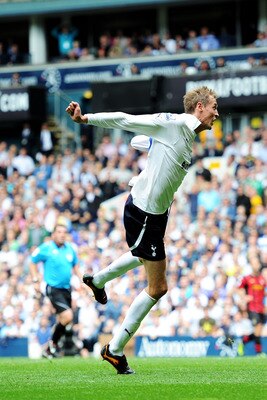 LONDON, ENGLAND - AUGUST 28:  Peter Crouch of Tottenham heads the ball wide as Joleon Lescott of Manchester City looks on during the Barclays Premier League match between Tottenham Hotspur and Manchester City at White Hart Lane on August 28, 2011 in Londo