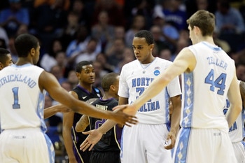 CHARLOTTE, NC - MARCH 20:  Dexter Strickland #1, John Henson #31 and Tyler Zeller #44 of the North Carolina Tar Heels react in the first half while taking on the Washington Huskies during the third round of the 2011 NCAA men's basketball tournament at Tim