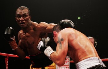 MANCHESTER, UNITED KINGDOM - OCTOBER 14:  Joe Calzaghe of Wales ducks a punch from Sakio Bika of Australia during the WBO and IBF super middleweight title fight at the MEN Arena on October 14, 2006 in Manchester, England.  (Photo by John Gichigi/Getty Ima