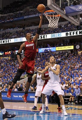 DALLAS, TX - JUNE 07:  Chris Bosh #1 of the Miami Heat attempts a shot against Dirk Nowitzki #41 of the Dallas Mavericks in the first half of Game Four of the 2011 NBA Finals at American Airlines Center on June 7, 2011 in Dallas, Texas. NOTE TO USER: User