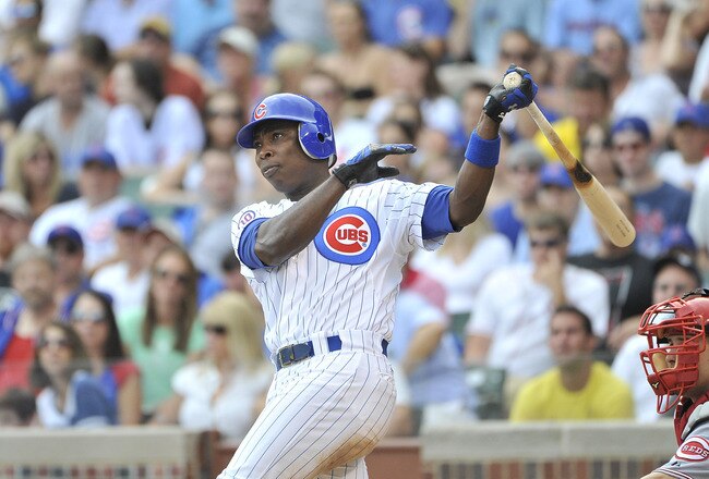 CHICAGO, IL - AUGUST 06:  Alfonso Soriano #12 of the Chicago Cubs follows through on an RBI double scoring Reed Johnson during the fourth inning against the Cincinnati Reds at Wrigley Field on August 6, 2011 in Chicago, Illinois.  (Photo by Brian Kersey/G