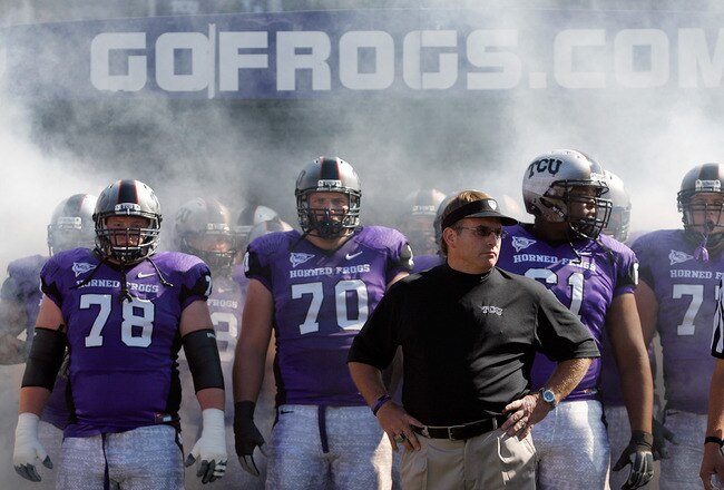FORT WORTH, TX - OCTOBER 16:  Head coach Gary Patterson of the TCU Horned Frogs takes to the field with offensive guard Josh Vernon #78 and tackle Zach Roth #70 against the BYU Cougars at Amon G. Carter Stadium on October 16, 2010 in Fort Worth, Texas.  (