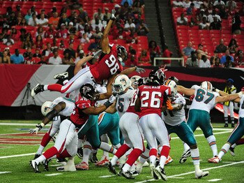 ATLANTA - AUGUST 12:  Emmanuel Stephens #96 of the Atlanta Falcons goes up to block an extra point against the Miami Dolphins during a preseason game at the Georgia Dome on August 12, 2011 in Atlanta, Georgia. (Photo by Scott Cunningham/Getty Images)