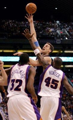 PHOENIX - APRIL 27:  Pau Gasol #16 of the Memphis Grizzlies shoots over Amare Stoudemire #32 and Steven Hunter #45 of the Phoenix Suns in Game two of the Western Conference Quarterfinals during the 2005 NBA Playoffs at America West Arena on April 27, 2005