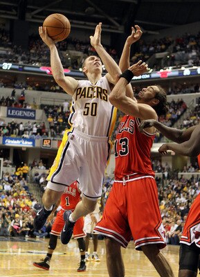 INDIANAPOLIS, IN - APRIL 21:  Tyler Hansbrough #50 of the Indiana Pacers shoots the ball while defended by Joakim Noah #13 of the Chicago Bulls in Game three of the Eastern Conference Quarterfinals in the 2011 NBA Playoffs on April 21, 2011  at Conseco Fi