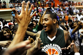 BALTIMORE, MD - AUGUST 30: Carmelo Anthony is mobbed by fans after the Goodman League All-Stars taking on The Melo League basketball game at Edward P. Hurt Gymnasium at Morgan State University on August 30, 2011 in Baltimore, Maryland. (Photo by Patrick S