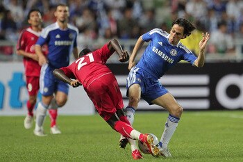 BANGKOK, THAILAND - JULY 24:  Yossi Benayoun #10 of Chelsea contests the ball with Dagno Siaka of Thailand during the pre-season friendly match between the Thailand All Stars and Chelsea at Rajamangala National Stadium on July 24, 2011 in Bangkok, Thailan