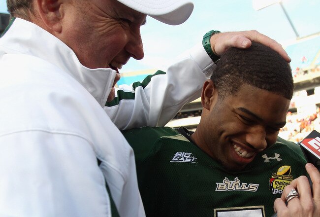 CHARLOTTE, NC - DECEMBER 31:  Head coach Skip Holtz stands with MVP B.J. Daniels #7 of the USF Bulls after a 31-26 victory over the Clemson Tigers at Bank of America Stadium on December 31, 2010 in Charlotte, North Carolina.  (Photo by Streeter Lecka/Gett