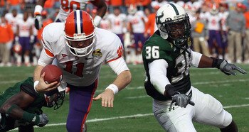 CHARLOTTE, NC - DECEMBER 31:  Sam Barrington #36 of the USF Bulls hits Kyle Parker #11 of the Clemson Tigers short of the goal line during their game at Bank of America Stadium on December 31, 2010 in Charlotte, North Carolina.  (Photo by Streeter Lecka/G