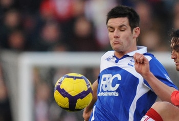 STOKE ON TRENT, ENGLAND - DECEMBER 28: Scott Dann (L) of Birmingham battles wth Tuncay of Stoke City during the Barclays Premier League match between Stoke City and Birmingham City at The Britannia Stadium on December 28, 2009 in Stoke on Trent, England. 