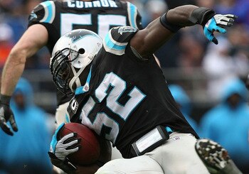 CHARLOTTE, NC - DECEMBER 06:  Jon Beason #52 of the Carolina Panthers runs with the ball after an interception during their game against the Tampa Bay Buccaneers at Bank of America Stadium on December 6, 2009 in Charlotte, North Carolina.  (Photo by Stree