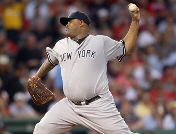 BOSTON, MA - AUGUST 30:  CC Sabathia #52 of the New York Yankees delivers a pitch in the first inning against the Boston Red Sox on August 30, 2011 at Fenway Park in Boston, Massachusetts.  (Photo by Elsa/Getty Images)
