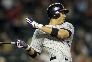 PHOENIX, AZ - AUGUST 30:  Carlos Gonzalez #5 of the Colorado Rockies bats against the Arizona Diamondbacks during the Major League Baseball game at Chase Field on August 30, 2011 in Phoenix, Arizona.  The Diamondbacks defeated the Rockies 9-4. (Photo by C