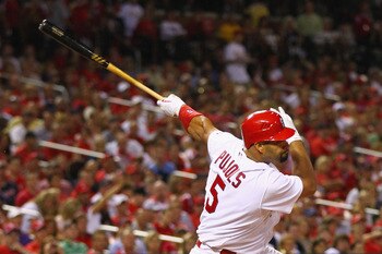 ST. LOUIS, MO - AUGUST 12: Albert Pujols #5 of the St. Louis Cardinals hits an RBI single against the Colorado Rockies at Busch Stadium on August 12, 2011 in St. Louis, Missouri.  The Cardinals beat the Rockies 6-1.  (Photo by Dilip Vishwanat/Getty Images