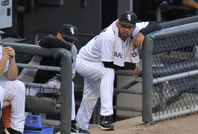 CHICAGO, IL - AUGUST 04:  Manager Ozzie Guillen #13 (R) of the Chicago White Sox and bench coach Joey Cora #28 stand in the dugout during the second inning at U.S. Cellular Field on August 4, 2011 in Chicago, Illinois.  (Photo by Brian Kersey/Getty Images