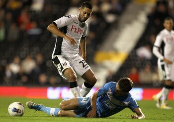 LONDON, ENGLAND - AUGUST 18:  Clint Dempsey of Fulham is tackled by Serhiy Kravchenko of FC Dnipro during the UEFA Europa League Play-Off round qualifying first leg match between Fulham and FC Dnipro Dnipropetrovsk at Craven Cottage on August 18, 2011 in