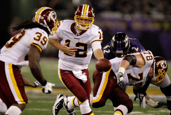 BALTIMORE, MD - AUGUST 25:  Quarterback John Beck #12 of the Washington Redskins hands the ball off to running back Tim Hightower #39 during a preseason game against the Baltimore Ravens at M&T Bank Stadium on August 25, 2011 in Baltimore, Maryland.  (Pho