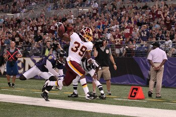 BALTIMORE, MD - AUGUST 25:  Tim Hightower #39 of the Washington Redskins scores a touchdown in front of Tom Zbikowski #28 of the Baltimore Ravens during the first half of a preaseason game at M&T Bank Stadium on August 25, 2011 in Baltimore, Maryland.  (P