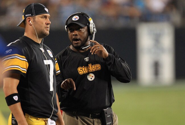 CHARLOTTE, NC - SEPTEMBER 01:  Head coach Mike Tomlin and Ben Roethlisberger #7 of the Pittsburgh Steelers talk on the sidelines during their preseason game against the Carolina Panthers at Bank of America Stadium on September 1, 2011 in Charlotte, North