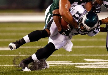 EAST RUTHERFORD, NJ - SEPTEMBER 01:  Kyle Wilson #20 and  Brashton Satele #48 of the New York Jets take down  Sinorice Moss #11 of the Philadelphia Eagles during their pre-season game at MetLife Stadium on September 1, 2011 in East Rutherford, New Jersey.