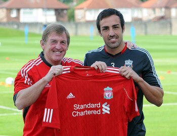 LIVERPOOL, ENGLAND - AUGUST 18:  (THE SUN OUT) In this handout photo provided by Liverpool FC, Manager Kenny Dalglish of Liverpool (L) with new signing Jose Enrique during a press conference at the club's Melwood training ground on August 18, 2011 in Live