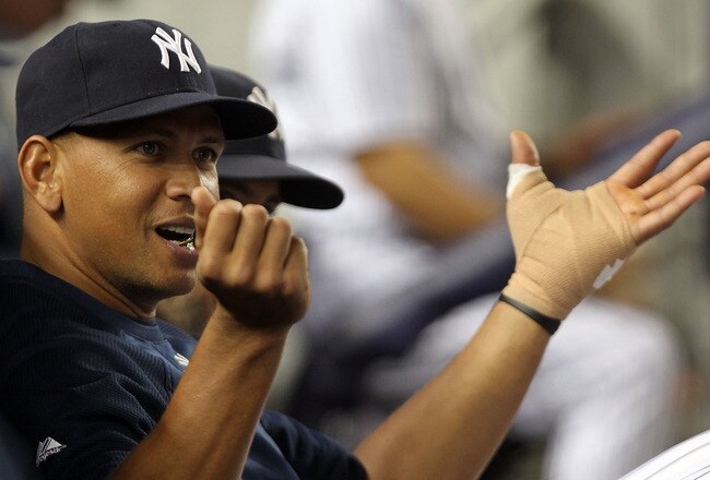 NEW YORK, NY - AUGUST 23:  Alex Rodriguez #13 of the New York Yankees watches on from the dugout with his left thumb heavily wrapped against the Oakland Athletics on August 23, 2011 at Yankee Stadium in the Bronx borough of New York City.  (Photo by Nick