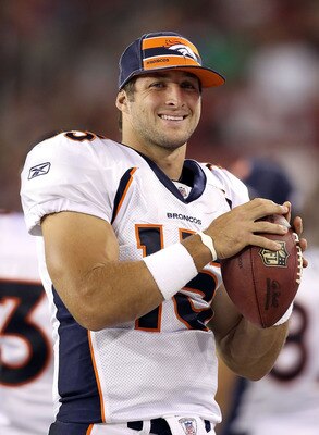 GLENDALE, AZ - SEPTEMBER 01:  Quarterback Tim Tebow #15 of the Denver Broncos warms up on the sidelines during the preseason NFL game against the Arizona Cardinals at the University of Phoenix Stadium on September 1, 2011 in Glendale, Arizona.  The Cardin