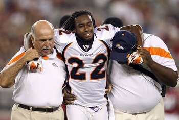 GLENDALE, AZ - SEPTEMBER 01:  Cornerback Syd'Quan Thompson #22 of the Denver Broncos is helped off the field by trainers after an injury against the Arizona Cardinals during the preseason NFL game at the University of Phoenix Stadium on September 1, 2011
