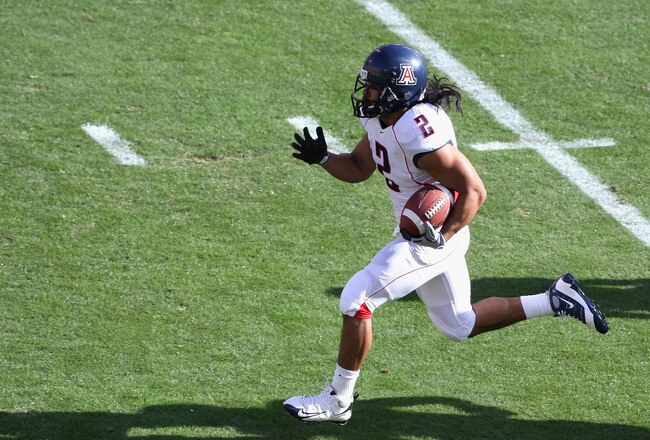 TEMPE, AZ - NOVEMBER 28:  Wide reciver Keola Antolin #2 of the Arizona Wildcats rushes for a 68 yard touchdown against the Arizona State Sun Devils during the college football game at Sun Devil Stadium on November 28, 2009 in Tempe, Arizona.  (Photo by Ch