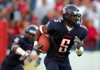TUCSON - OCTOBER 23:  Antoine Cason #5 of Arizona makes an interception off of a deflection by Wilrey Fontenot #3 in the second quarter at Arizona Stadium on October 23, 2004 in Tucson, Arizona.  California won 38-0.  (Photo by Harry How/Getty Images)