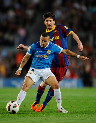 BARCELONA, SPAIN - APRIL 09:  Lionel Messi of FC Barcelona (R) fights for the ball againstAlbert Crusat Domene of Almeria during the La Liga match between FC Barcelona and UD Almeria at Camp Nou on April 9, 2011 in Barcelona, Spain.  (Photo by David Ramos