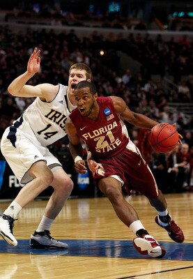 CHICAGO, IL - MARCH 20:  Michael Snaer #21 of the Florida State Seminoles drives against Scott Martin #14 of the Notre Dame Fighting Irish in the first half during the third round of the 2011 NCAA men's basketball tournament at the United Center on March