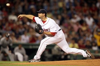 BOSTON, MA - AUGUST 31:  Josh Beckett #19 of the Boston Red Sox delivers a pitch in the second inning against the New York Yankees on August 31, 2011 at Fenway Park in Boston, Massachusetts.  (Photo by Elsa/Getty Images)