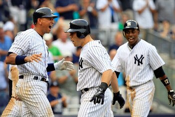 NEW YORK, NY - AUGUST 25:  Russell Martin #55 of the New York Yankees is congratulated by teammates Alex Rodriguez #13 and Curtis Granderson #14 on his grand slam home run in the sixth inning against the Oakland Athletics on August 25, 2011 at Yankee Stad