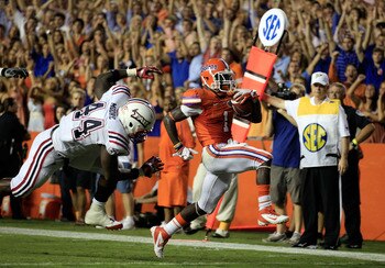 GAINESVILLE, FL - SEPTEMBER 03:   Chris Rainey #1 of the University of Florida Gators scores a touchdown past Tony Moore #44 of the Florida Atlantic University Owls during a game at Ben Hill Griffin Stadium on September 3, 2011 in Gainesville, Florida.  (